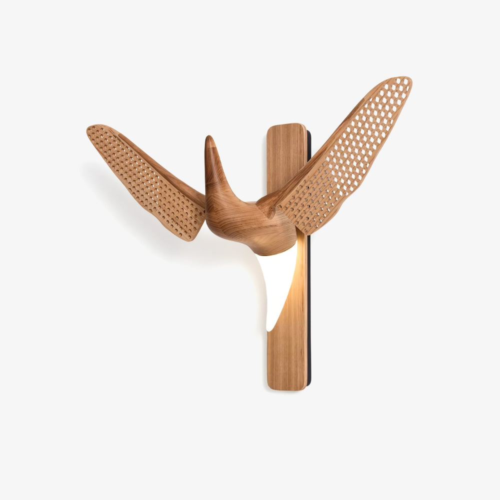 Wide wall sconce, carved wood wings spread either side of a lit body