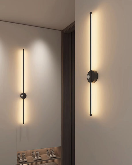 Two rods lit along a corridor beside an open doorway and a dark timber frame