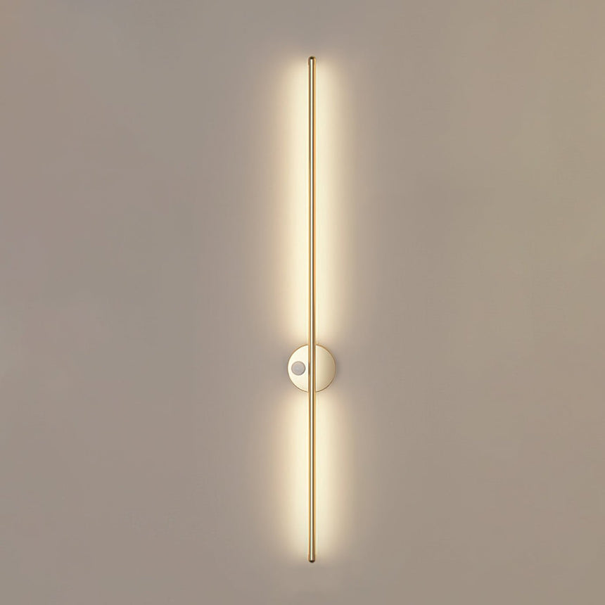 The gold version lit, the warm rod running the full height of the fitting