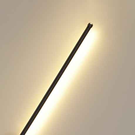The rod seen at an angle, the lit face turned toward the wall behind it