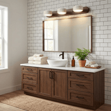 Four light travertine bar lit above a mirror over a wood vanity unit