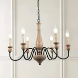 The six candle bulbs lit against a paneled white wall and a doorway