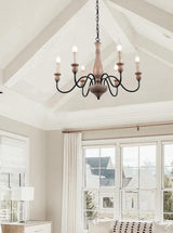 Hung under a white vaulted ceiling in a bright room with tall windows and a pale sofa