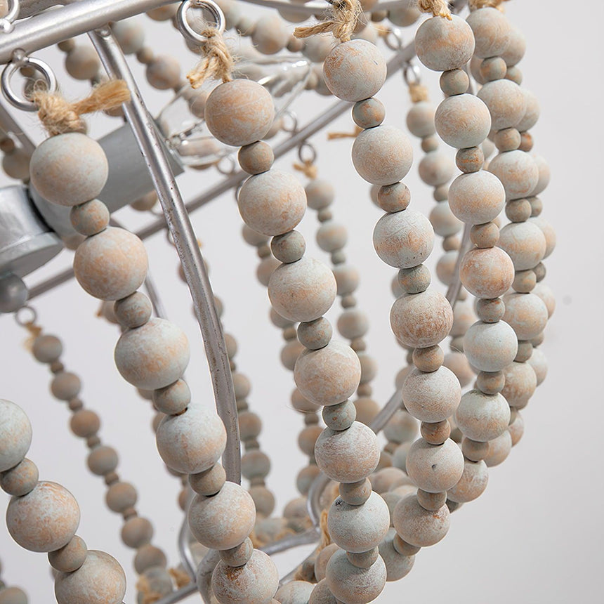 The strands tied with twine to the metal ring, beads seen close
