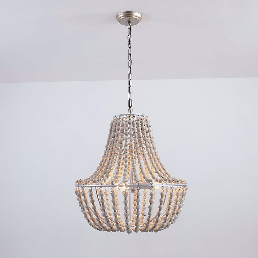 The fitting lit in a plain white room, showing the chain and the round canopy