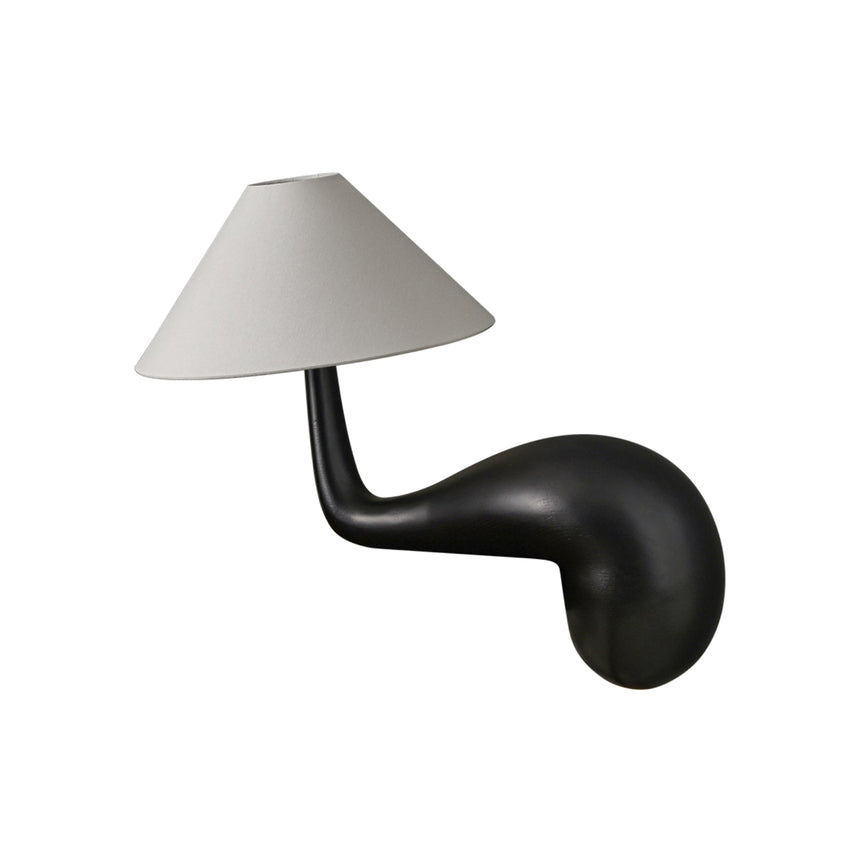Black wood desk lamp seen from the side against a plain ground