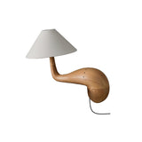 Wood desk lamp in natural wood seen from the front, plain ground