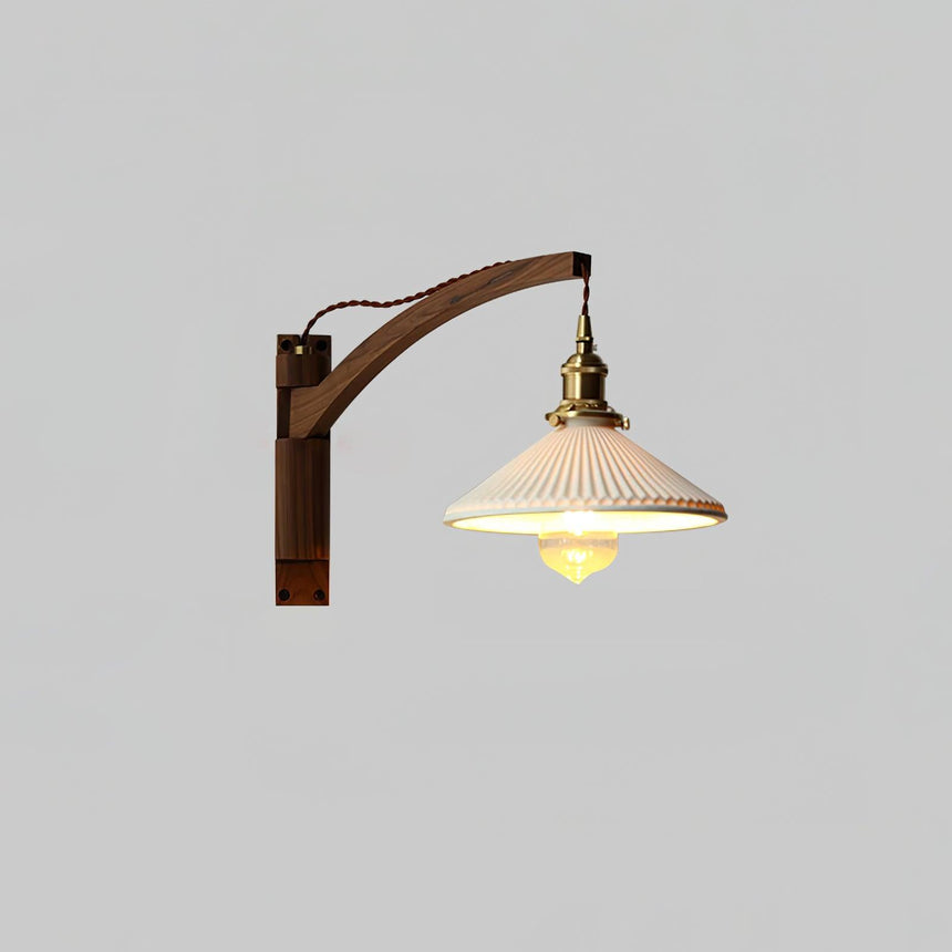 The curved arm lamp lit on a pale gray background