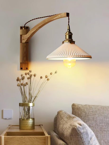 The curved arm version lit warm above dried flowers in a glass vase