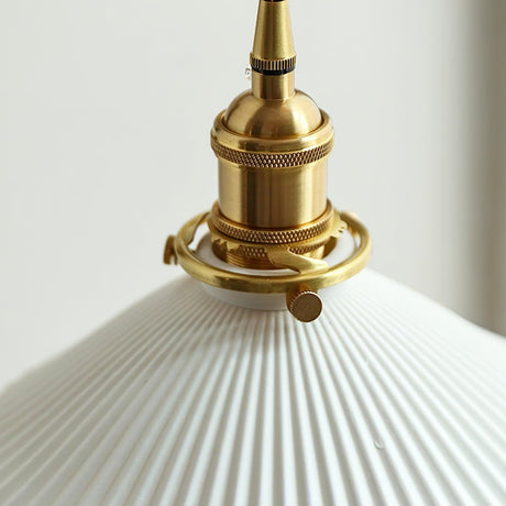 Close view of the knurled brass socket above the pleated shade