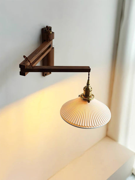 The folding arm version lit beside a window, light falling on the sill