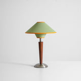 Wood table lamp with the green two tier shade on a plain background