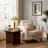 Wood table lamp on a side table in a pale living room