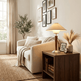 Wood table lamp on a console beside a sofa and framed prints