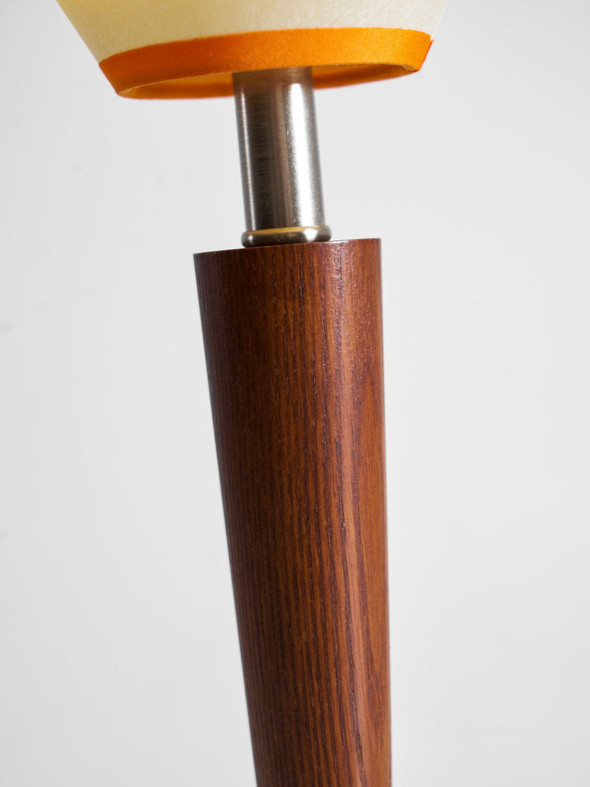 Close view of the turned walnut column and the nickel collar