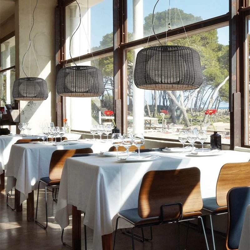 Three of the shades in a row above set tables beside a wall of windows