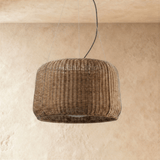 The wicker weave seen close, the vertical strands pulled in at the waist
