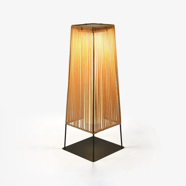 Tapered woven shade in a warm straw tone on a slim dark metal stand