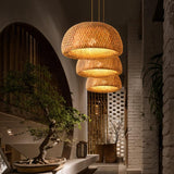 Shades lit in a row beside an arched doorway with a bonsai on a stone ledge