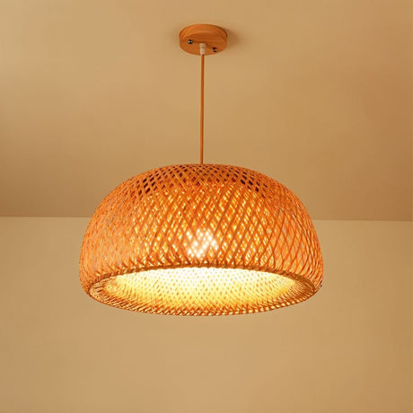 A wide shallow rattan bowl shade woven in a fine diamond mesh and lit warm