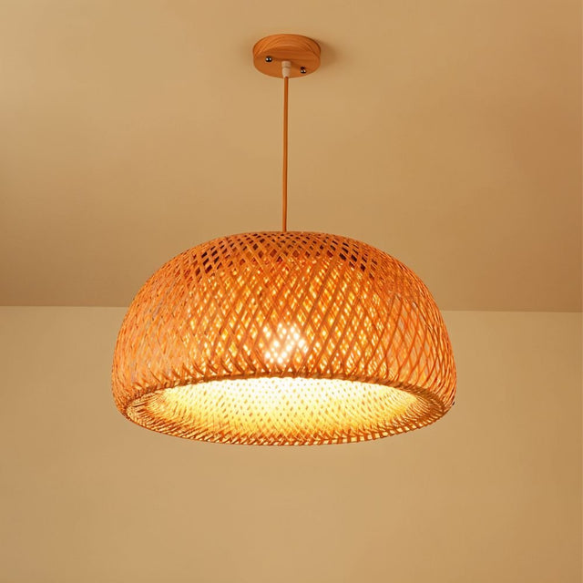 A wide shallow rattan bowl shade woven in a fine diamond mesh and lit warm