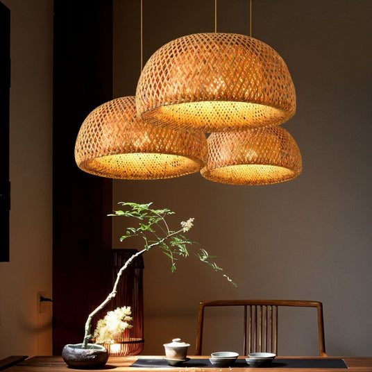 Three of the shades lit above a low tea table with a branch arrangement beside it