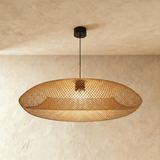 A wide flattened rattan shade, braided in a fine diamond mesh, lit from inside