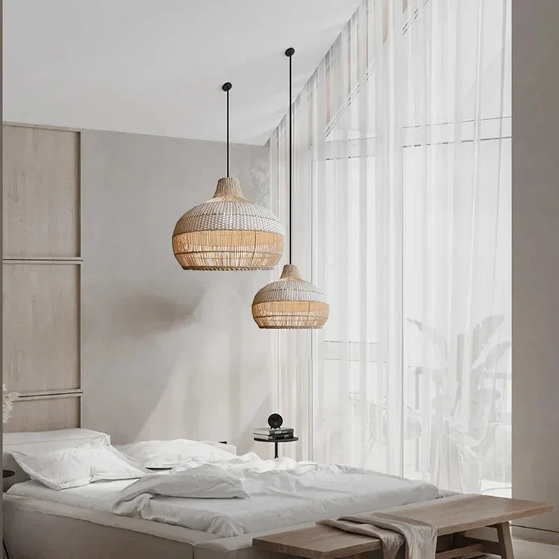 Two woven rattan shades hung beside a bed