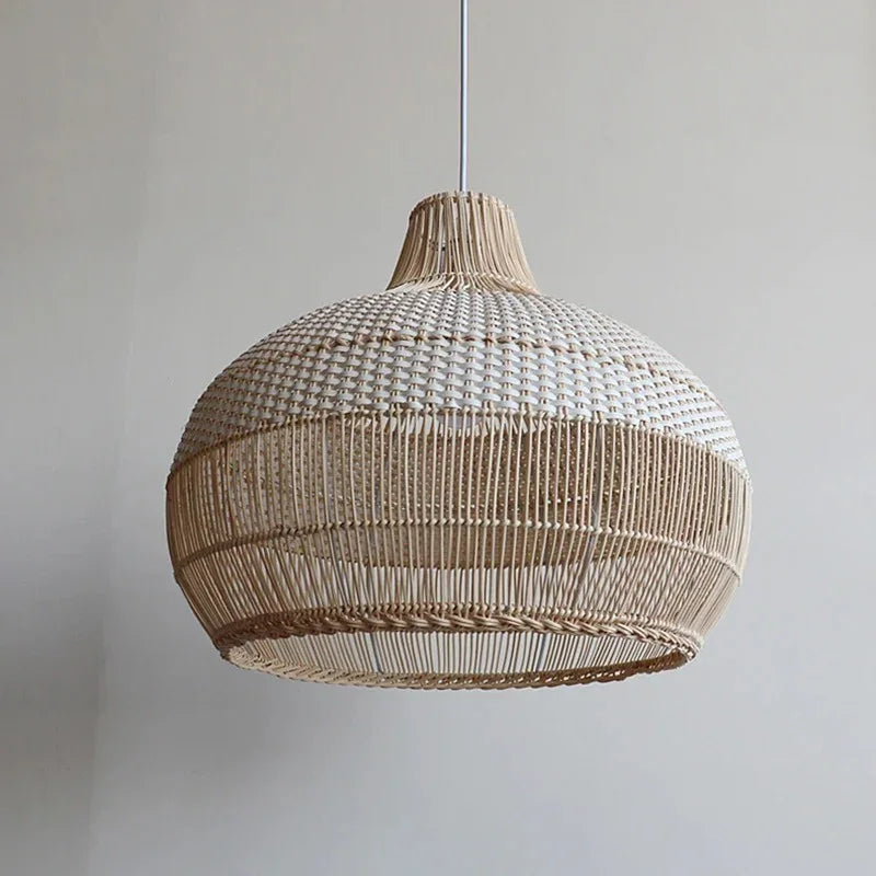 Close view of the woven rattan bell against a pale wall