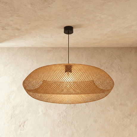 The braided shade lit warm, the mesh open enough to show the lamp within