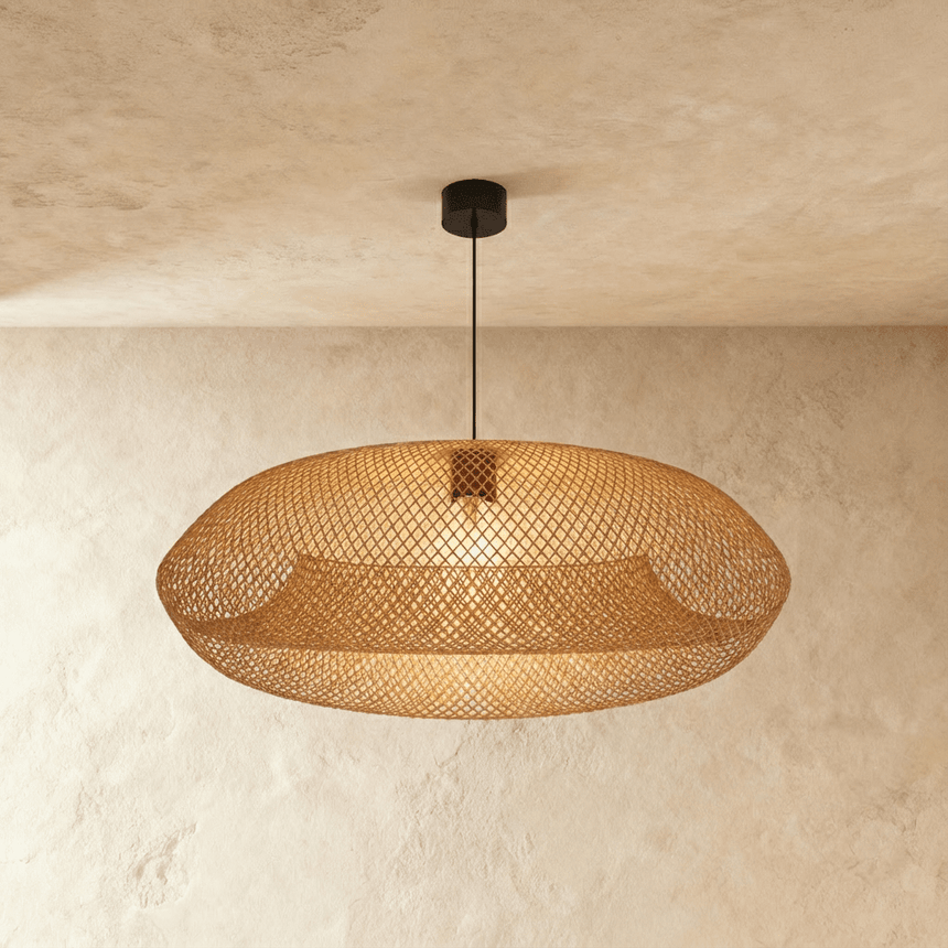 The braided shade lit warm, the mesh open enough to show the lamp within