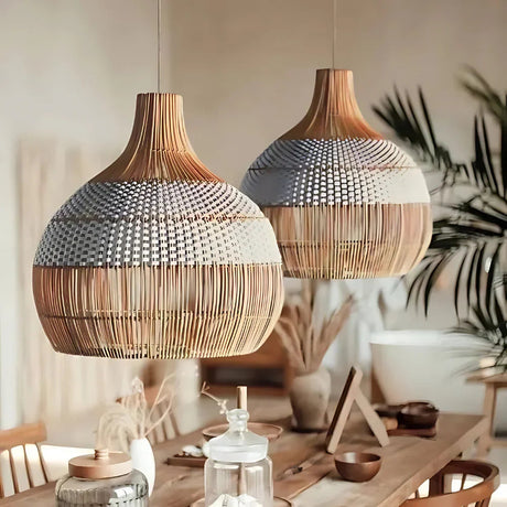 Two woven rattan shades above a table in a warm room