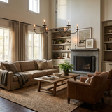 Hung in a double height room above a sofa with a fireplace and shelving