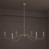 The satin nickel version against a dark wall, arms curving from the hub