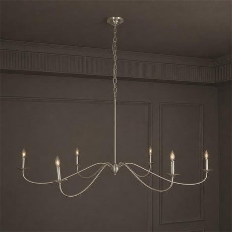 The satin nickel version against a dark wall, arms curving from the hub