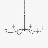 Six black wrought iron arms curving out in S shapes with candle cups on each
